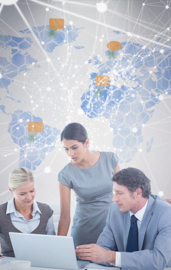 Business people using laptop against world map